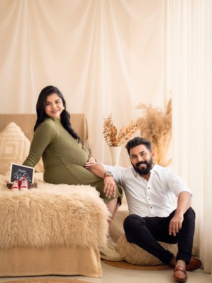 A happy family portrait with the couple and their "first baby picture," the sonogram, in our warm and inviting boho studio.