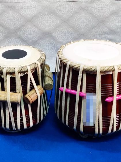 This is a traditional wooden tabla set, featuring a 12-inch dhama (left bayan). This classic design is perfect for students and practitioners looking for an authentic, rich percussive sound.