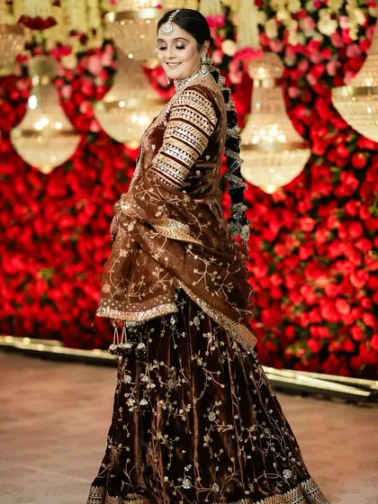 The full view of this magnificent bridal look. The makeup ties together the entire ensemble, from the detailed outfit to the statement jewelry, creating a look of pure royal elegance.