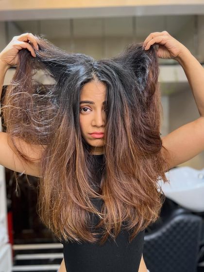 This is the "before" shot of hair that's become frizzy and lost its shape. It's the perfect canvas for a smoothing treatment and color correction to bring it back to life.