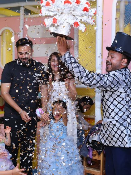 The magic continues with a confetti blast from the magician's top hat. These moments of surprise and wonder are what make our parties truly special.