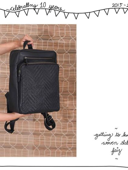 A closer look at the Woven Slate Faiz backpack. The combination of the smooth, solid leather body and the textured woven front pocket creates a subtle yet sophisticated contrast.