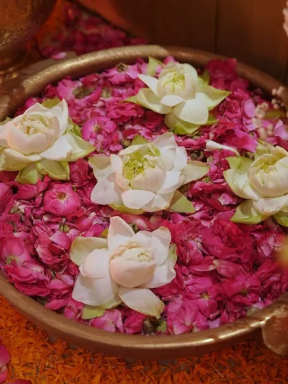 For a Ganpati puja, the details create a sense of peace and devotion. Here, I used a traditional brass urli filled with fresh rose petals and floating lotus flowers, set against a bed of marigolds, to create a beautiful and sacred offering space.