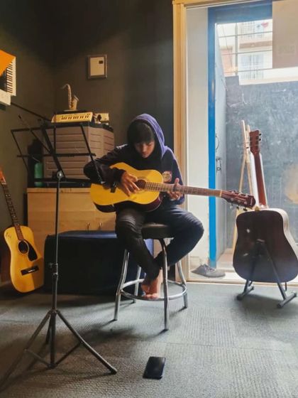A quiet moment of focus during a guitar lesson. Our studio is designed to be a distraction-free zone where students can concentrate on their music.