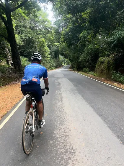 Riding through a lush, green forest road during the Jog Falls 1000K BRM. The beauty of the Western Ghats is a constant companion on this epic ride.