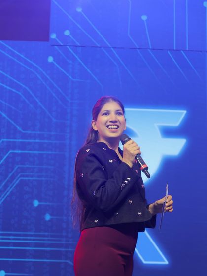 A close-up shot during the HDFC event, interacting with the audience. As a corporate emcee, I make sure to connect with attendees both on and off the stage.