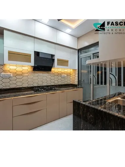 This kitchen at Lodha Belair features beige cabinets with profile handles and a hexagonal tile backsplash. The design is both modern and warm, creating a welcoming cooking space.