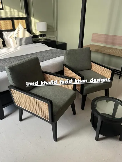 A seating arrangement in a hotel room, featuring two of my custom lounge chairs and a small table.