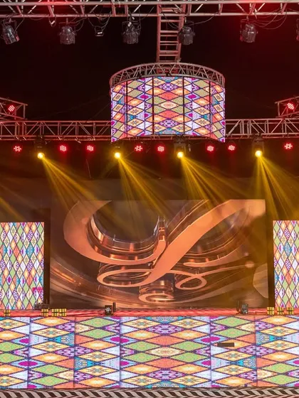 Another look at the versatile Sangeet stage, with the LED screens displaying a different graphic. This flexibility allows for custom backdrops for each performance, enhancing the storytelling of the night.