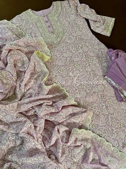 Our hand-embroidered Chikankari Anarkali in a delicate lilac hue. This pure georgette piece features a heavy, all-over jaal work, perfect for sophisticated festive wear.