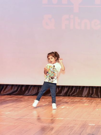 Dea owning the stage with her confident moves. Our training helps kids feel comfortable and expressive in front of an audience.