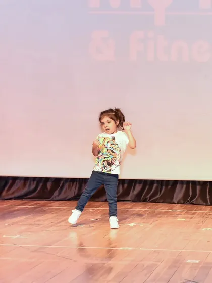 Dea owning the stage with her confident moves. Our training helps kids feel comfortable and expressive in front of an audience.
