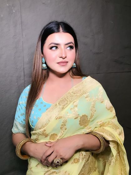 Feeling beautiful in this saree. A soft, natural makeup look that complements the pastel colors of the saree, perfect for an elegant daytime event.