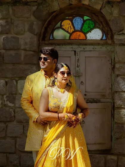 A cool couple portrait from their Haldi day. Dressed in yellow and wearing sunglasses, they look effortlessly stylish.