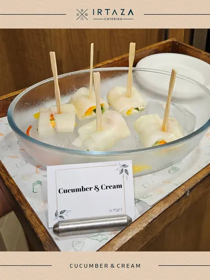 A refreshing appetizer of Cucumber & Cream rolls. Thin slices of cucumber are wrapped around a creamy filling, offering a light and crisp bite that's perfect for any occasion.