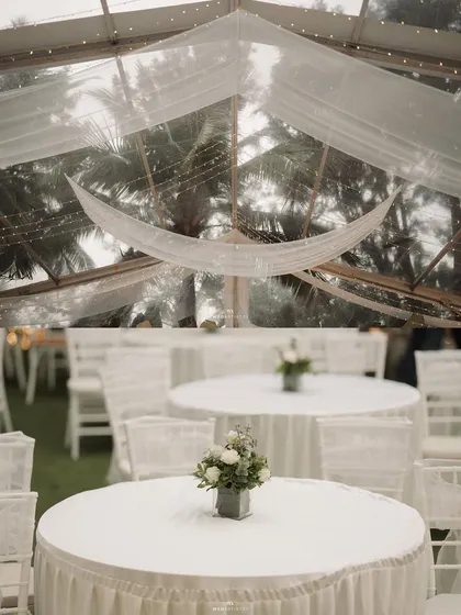 A serene and elegant all-white wedding reception theme. The clear-top tent allows guests to dine under the stars, while the minimalist decor highlights the natural beauty of the surrounding greenery at The Farmhouse Collective.