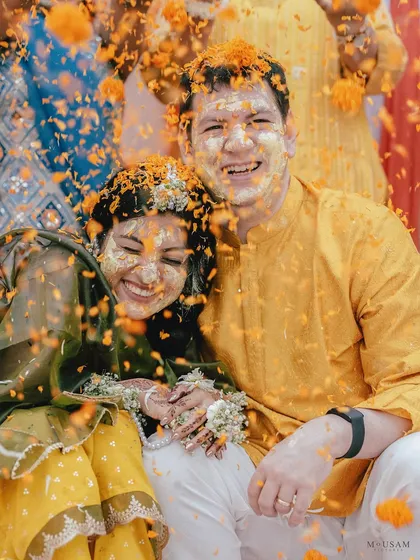 The Haldi ceremony is pure, unadulterated joy. It’s a celebration painted in the brightest yellow, filled with laughter and the blessings of loved ones. I love capturing the playful chaos, like this shower of marigold petals, where smiles are brighter than the sun. These are the moments of pure 'masti' that become cherished memories.