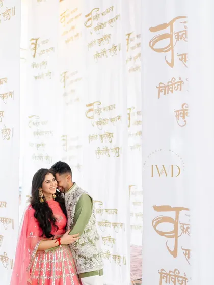 A beautiful portrait of a couple amidst the hanging scrolls. The Sanskrit prayers create a meaningful and artistic backdrop for their pre-wedding photos.