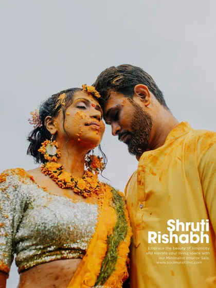 A powerful portrait of the couple during their Haldi. The simple background and their intense connection create a striking and emotional image, styled like a movie poster.