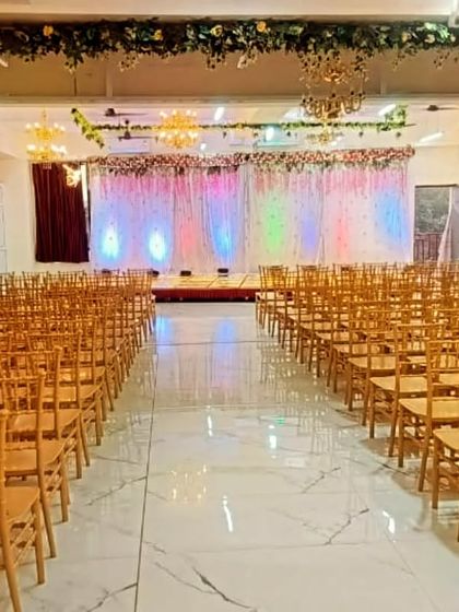 This is our Badlapur hall set up for a large event with theatre-style seating. The clean, spacious area with a decorated stage at the front is perfect for conferences or receptions.
