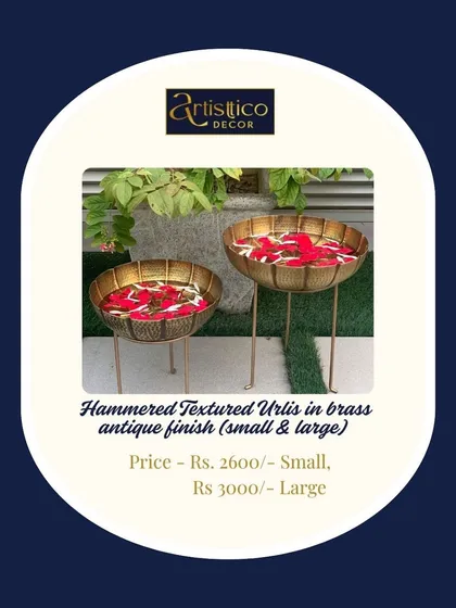 These hammered textured urlis come with stands, giving them height and presence. Available in a brass antique finish, they are ideal for decorating walkways or corners during wedding festivities.