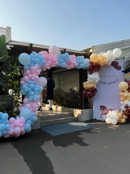 A beautiful pastel balloon arch welcomes guests to the 'Vantara in the Saddle' event, setting a celebratory mood right from the entrance.