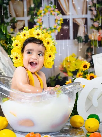 A big, happy splash in a sunflower-themed milk bath. This is a perfect way to end a first birthday or cake smash session.