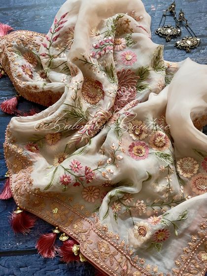 A flat-lay of the dupatta with earrings, highlighting the beautiful tassels and border work.