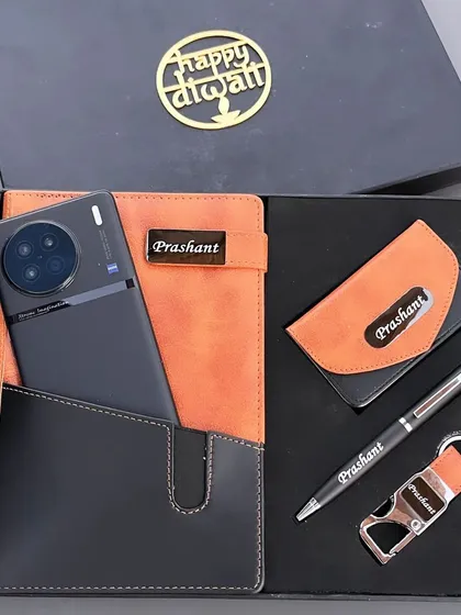 A modern and practical Diwali gift set for corporate clients. This hamper includes a personalized multi-functional diary with a phone slot, a matching pen, keychain, and card holder.