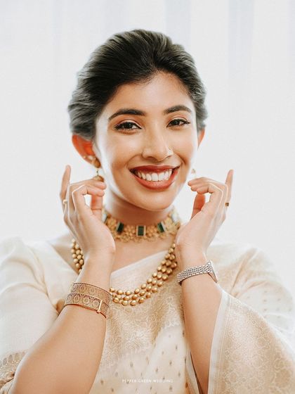 A close-up of the bride's happy and radiant smile, a perfect capture of her wedding day glow.