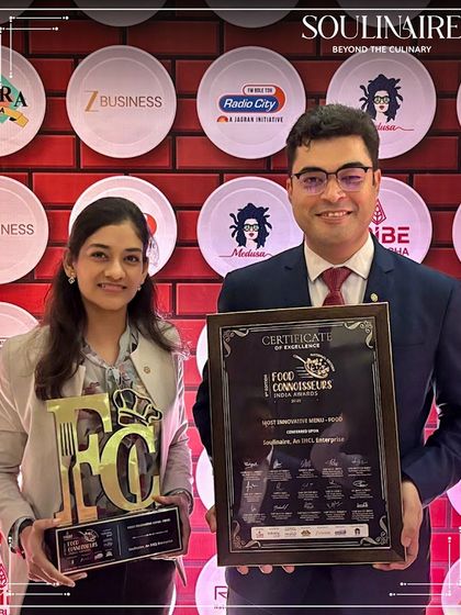 Our team members holding the trophy and certificate for "Most Innovative Menu" at the Food Connoisseurs India Awards.