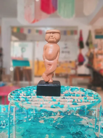 "No one is YOU & that is your Power." This quirky, hand-carved wooden figure stands proudly, a small reminder of the beauty of being unique.