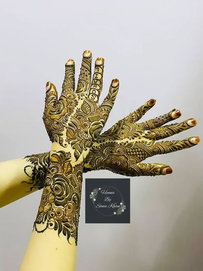 A graceful and elegant floral design, with the hands crossed to show the full scope of the artwork.