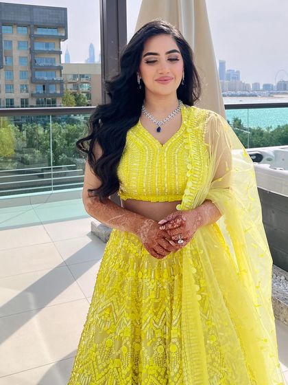 The bride's happy and serene look, her wavy hair perfectly styled.