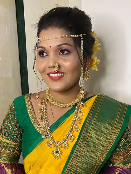 My bride Urvashi, looking stunning in her yellow and green wedding saree, complete with the traditional mundavalya and nath.