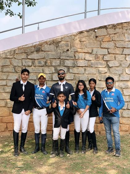 A group of our riders and trainers at the Embassy International Riding School. This photo captures the spirit of teamwork and camaraderie that defines Team Royal.