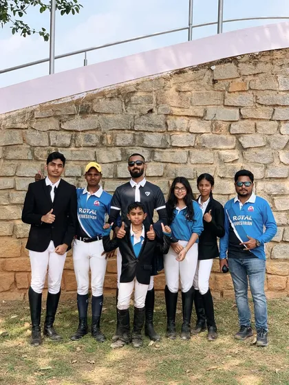 A group of our riders and trainers at the Embassy International Riding School. This photo captures the spirit of teamwork and camaraderie that defines Team Royal.