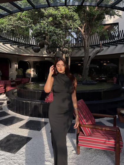 A final, graceful pose in the elegant black dress.