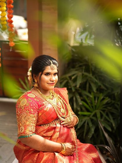My favourite client Shruthi at her Valaikaappu (baby shower). I draped her beautiful red silk saree to be comfortable and elegant, ensuring she felt special on her big day.