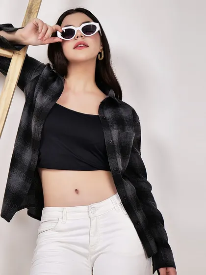 A model styled in a black and grey plaid shirt, demonstrating a casual, layered look. This type of image is great for lookbooks and social media content.