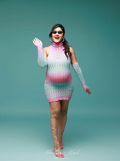 A fun, candid wave from our Barbie-inspired shoot, showing the joyful and playful side of maternity photography.