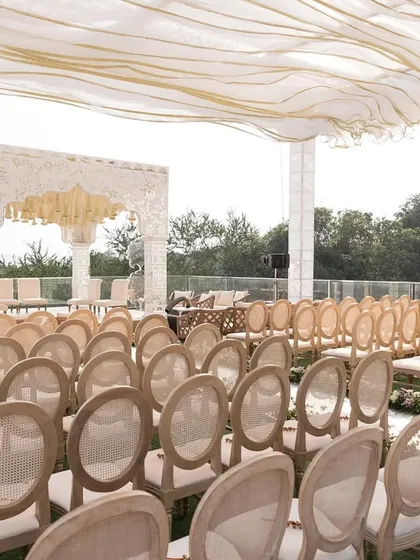 Another angle of the Alibaug wedding setup, showing the clean lines of the seating arrangement and the mirrored aisle leading to the mandap.