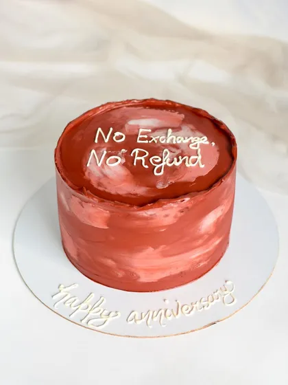 A funny anniversary cake for a couple with a great sense of humor. The cake, with its rustic red texture, reads "No Exchange, No Refund" for a playful touch.