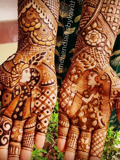 A close-up of a bride and groom portrait design on the palm. I focus on getting the details right, from the facial expressions to the traditional attire, to capture the essence of the couple.