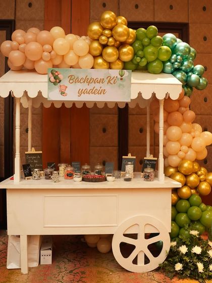 A nostalgic 'Bachpan Ki Yaadein' (Childhood Memories) candy cart. This station is filled with classic Indian candies, offering a sweet and sentimental treat for guests of all ages.