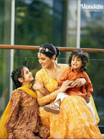 A beautiful family moment, with the little one looking happy and comfortable in his simple orange kurta. Our designs are perfect for every member of the family.