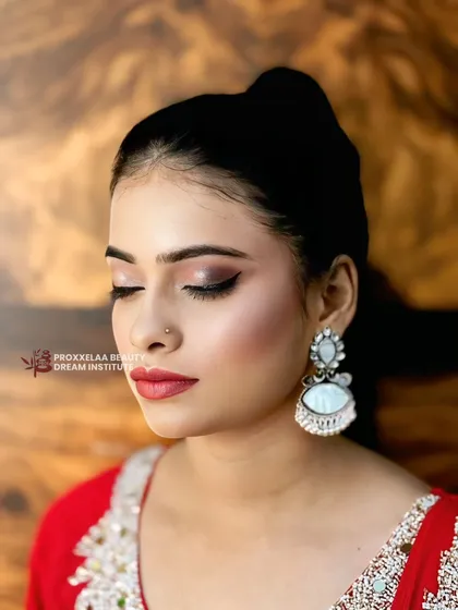 Serving all the glam with this stunning Indian party makeup. The look features a soft smokey eye, flawless skin, and a beautiful red lip, perfect for any festive occasion.