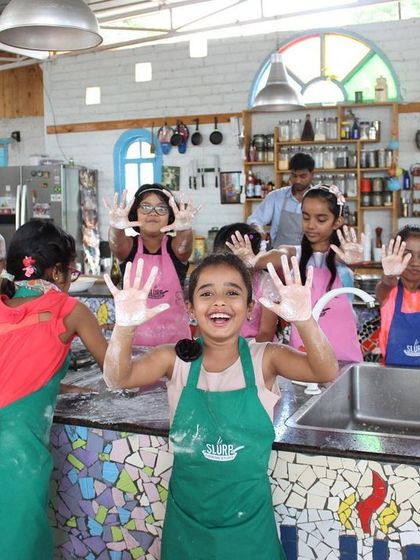 The joy of getting your hands messy with flour! We encourage kids to dive into the cooking process, making learning fun and interactive.
