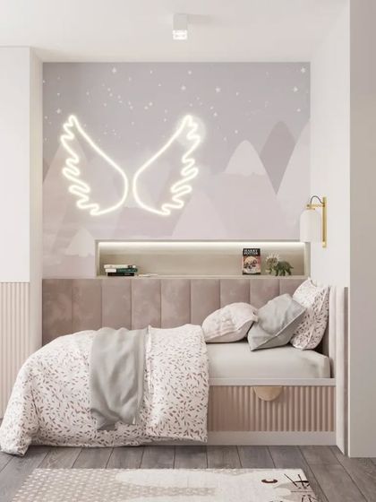 This child's room features a soft, neutral color palette with a custom bed and headboard. A cute hippo art print and a neon angel wing light add a touch of personality.