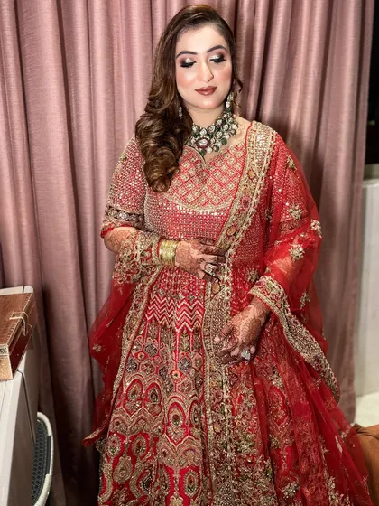 This bride looked absolutely regal in her red lehenga. I gave her a full-glam look with defined eyes, contoured cheeks, and a complementary lip color, ensuring she felt like a queen on her big day.